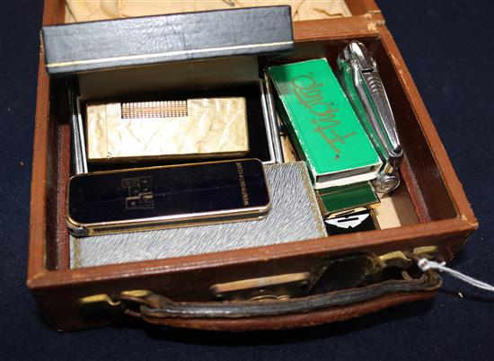 Two Dunhill lighters and five other assorted lighters.
